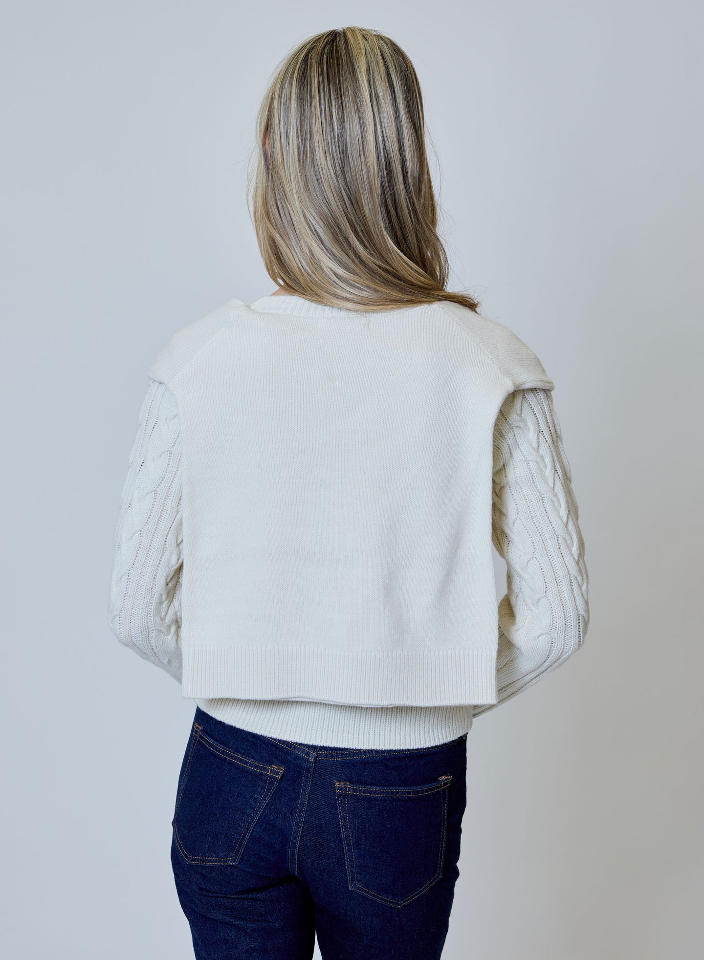 Canvas Double Layer Sweater by design history shown from the back with layered knit sleeves