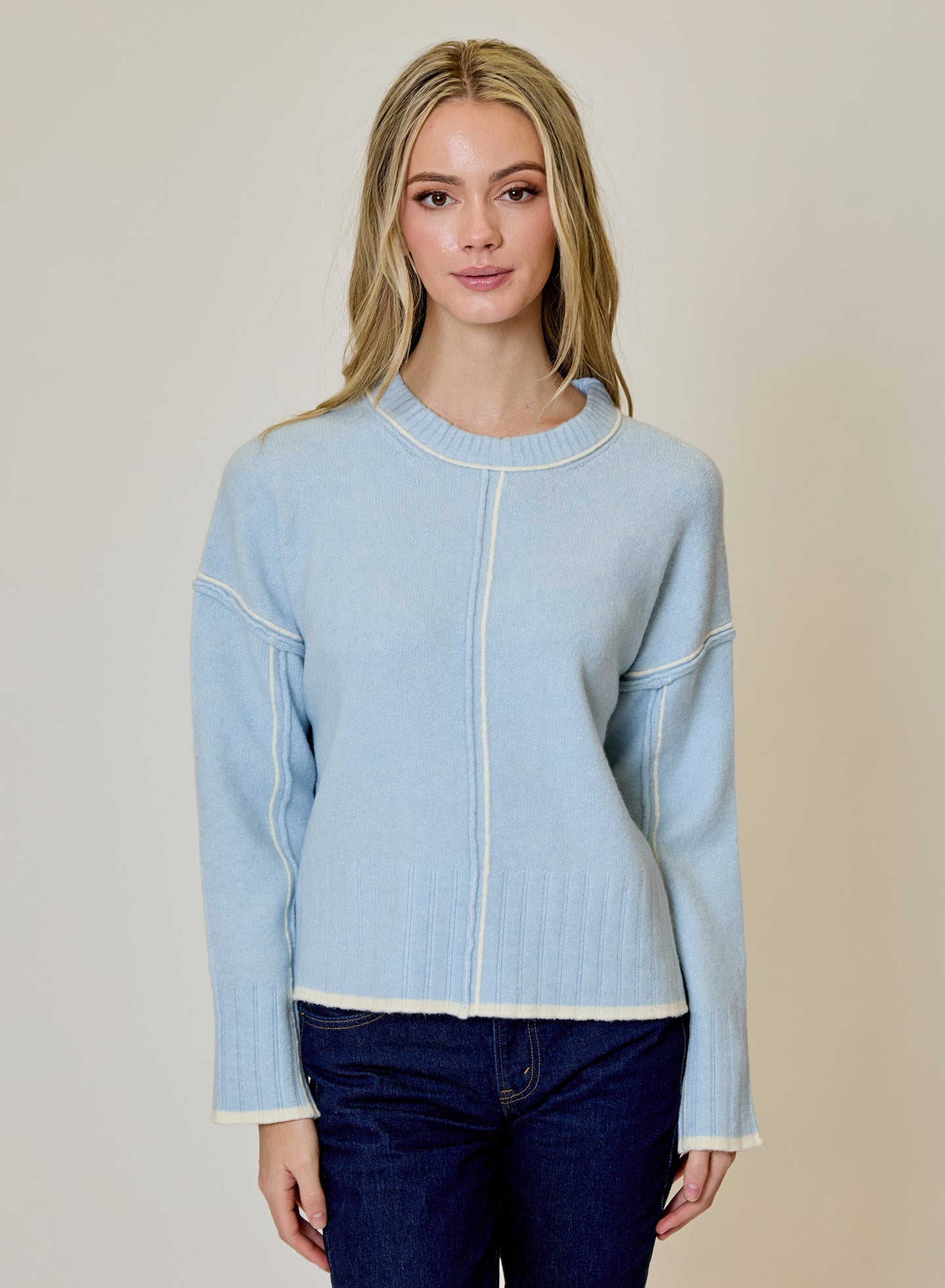 Blue Echo Sweater by design history in light blue with contrast seams and ribbed trim worn with dark jeans