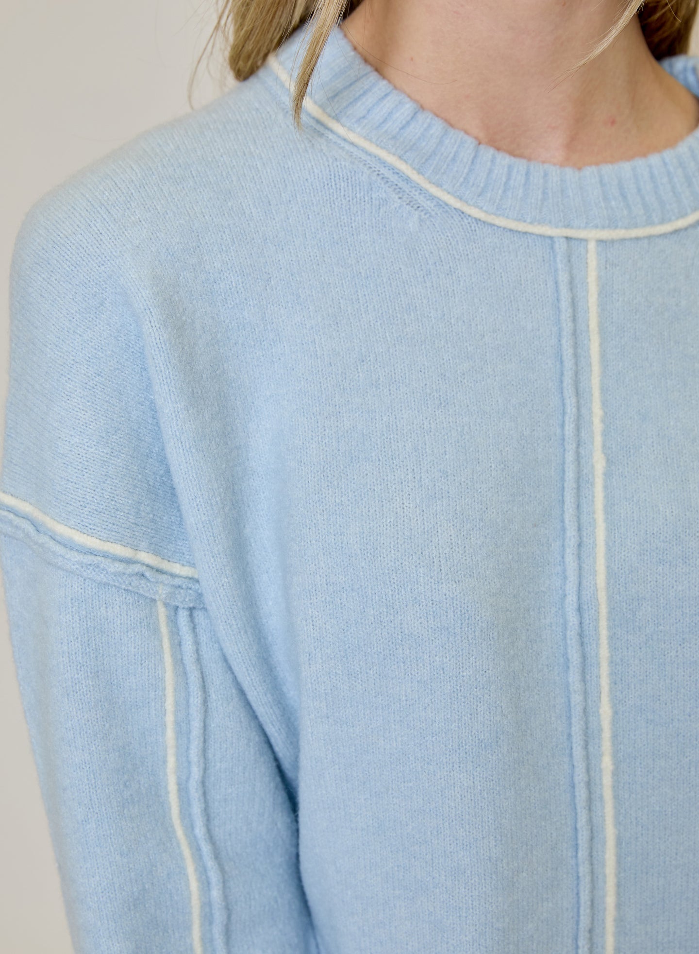 Blue Echo Sweater by design history in light blue knit with cream contrast trim