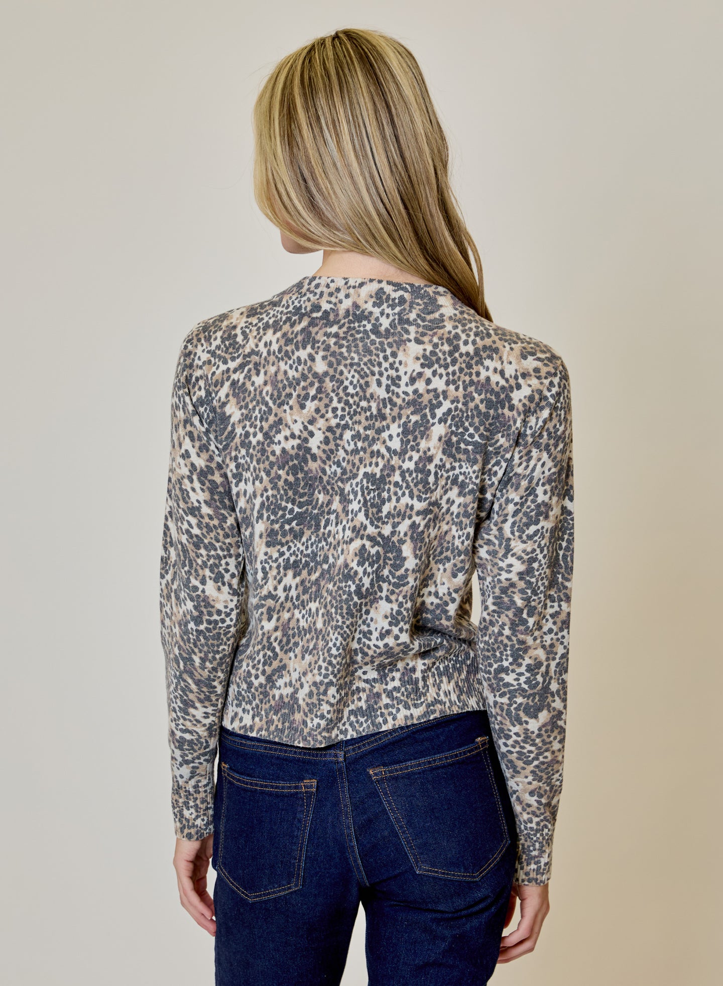 Animal Print Cardigan by design history shown from the back in leopard print with dark jeans