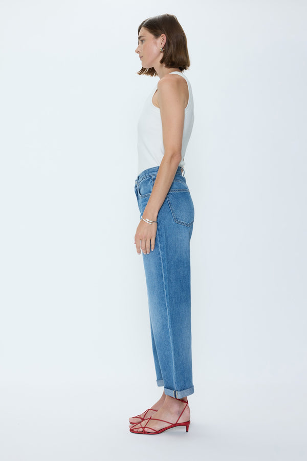 Side view of a model wearing Heartfelt Donny jeans by pistola with a high rise and wide leg cuffed hem