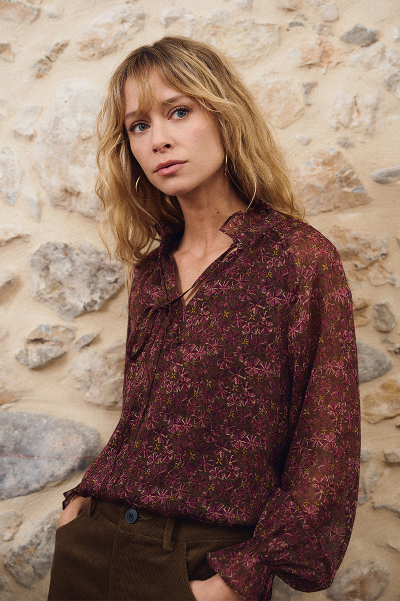 Khaki Olga Shirt by Molly Bracken worn by a model against a rustic stone wall