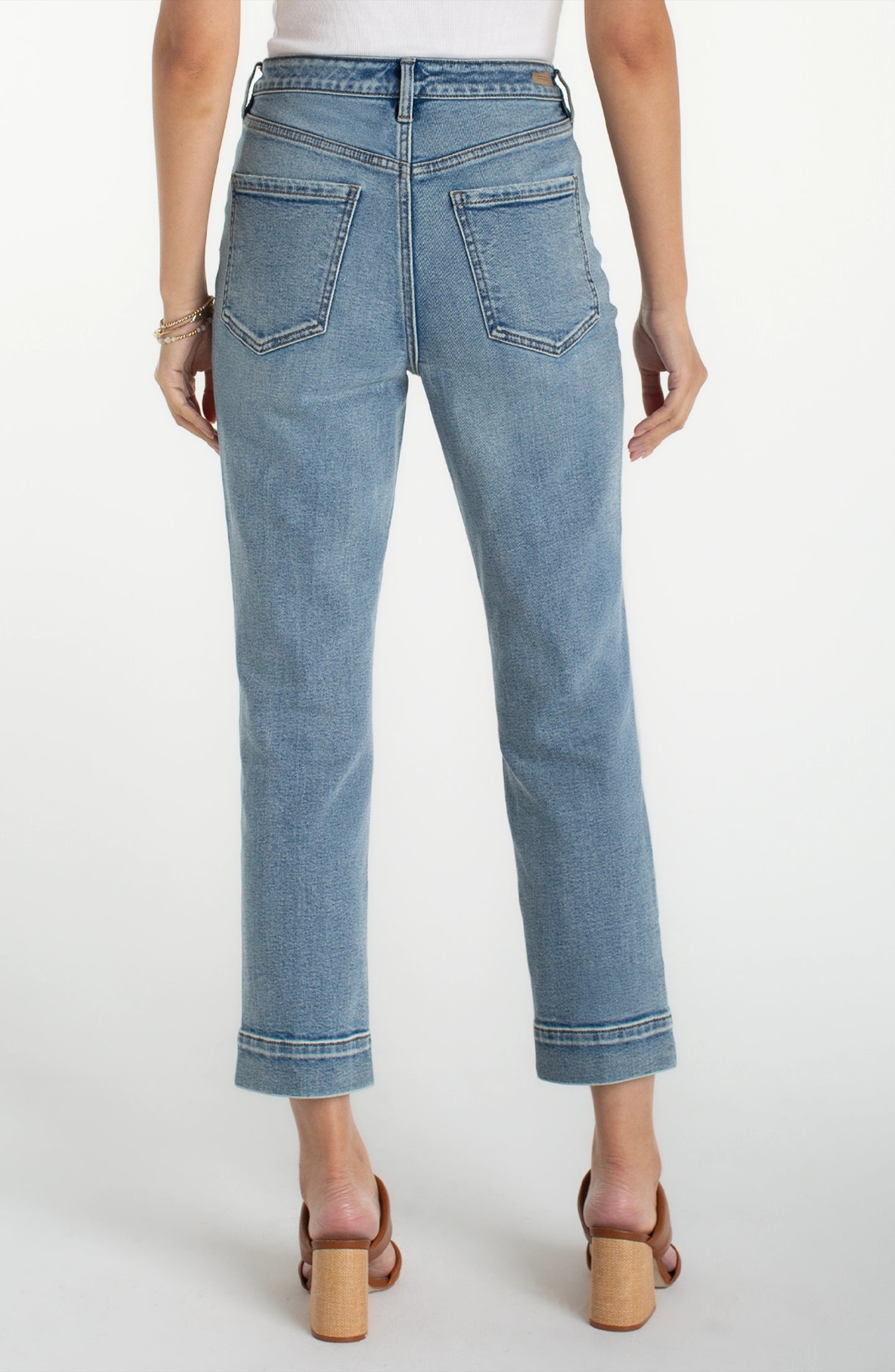 Back view of woman wearing liverpool Symphony HR Liv Relaxed Crop Skinny With Wide Hem 27" Inseam jeans in light blue denim