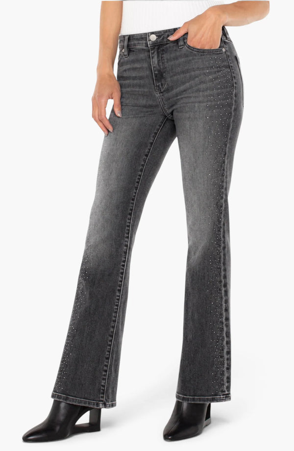 Liverpool Bootcut Jeans in dark gray denim with a fitted waist and flared legs styled with black ankle boots