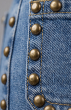 Close-up of bronzed studs on blue denim fabric of Bronzed Blue Hannah Flare with Patch Pockets & Studs by liverpool