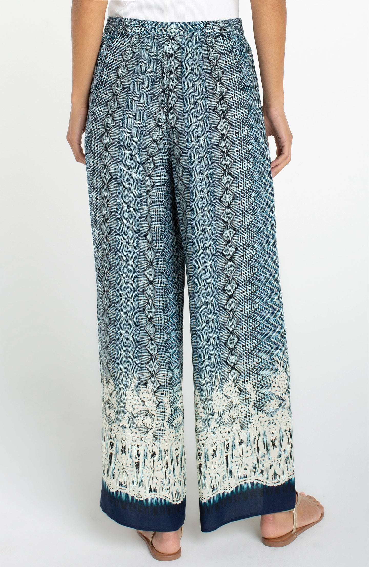 Back view of Liverpool Nomad Ikat Print Pull-on Palazzo Pant 2" Inseam with blue and white intricate pattern.