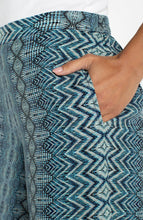 Close-up of hand in pocket showcasing the blue patterned Nomad Ikat Print Pull-on Palazzo Pant 2