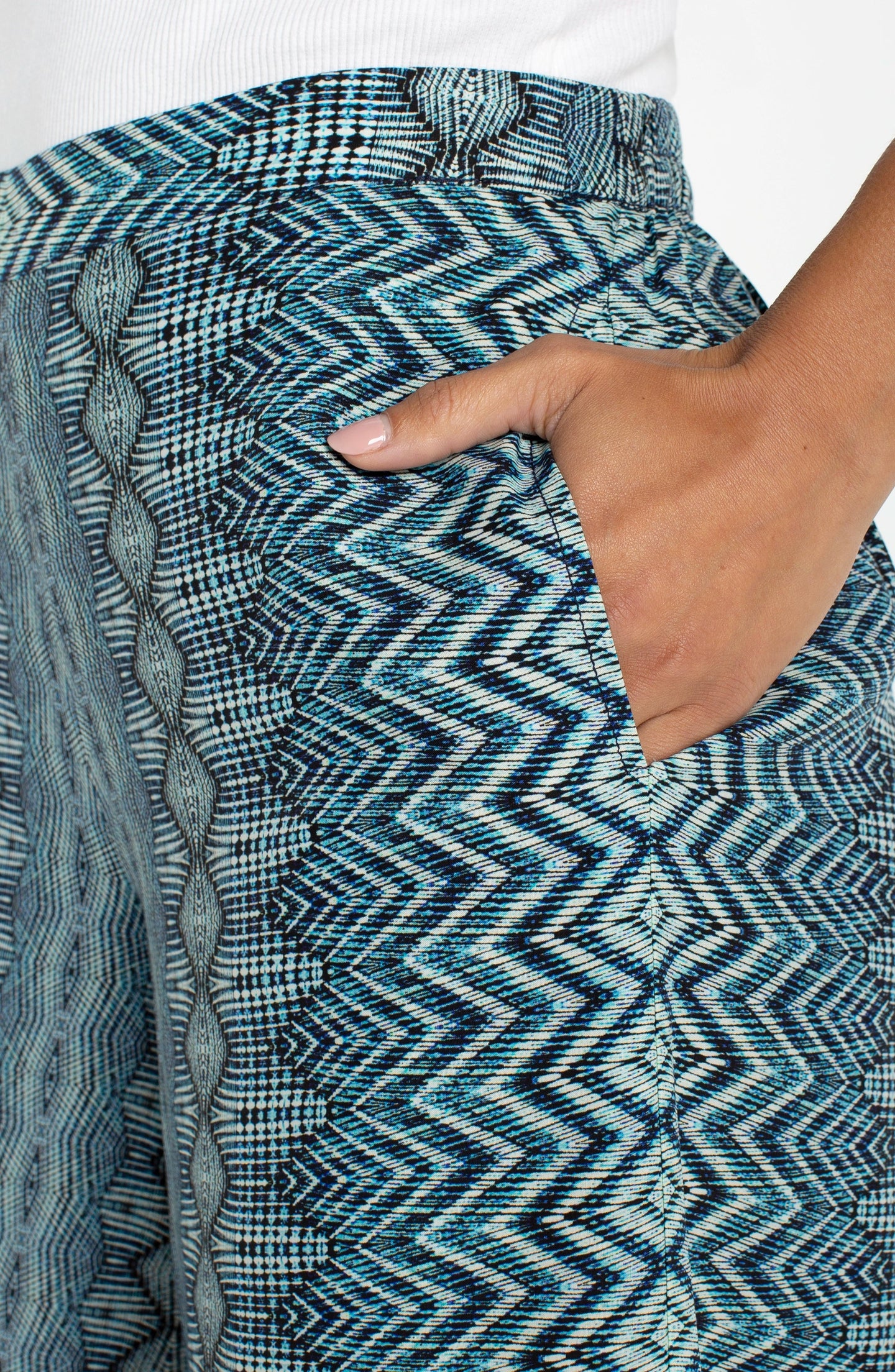 Close-up of hand in pocket showcasing the blue patterned Nomad Ikat Print Pull-on Palazzo Pant 2" Inseam by liverpool