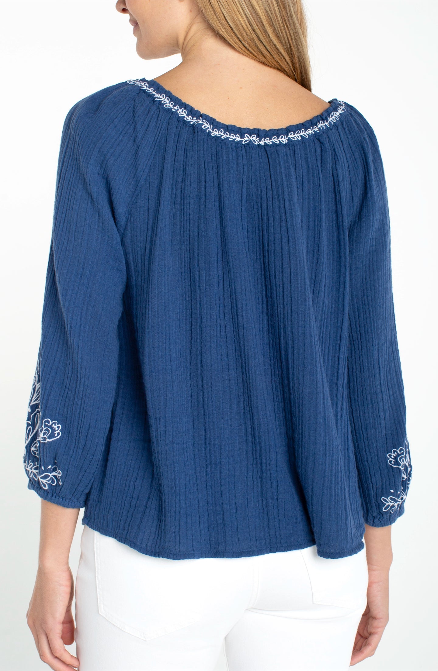 Back view of woman wearing Liberty Blue 3/4 Sleeve Woven Top with Embroidery by liverpool in blue fabric with white embroidery details.