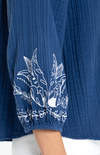 Close-up of a blue textured sleeve with white floral embroidery on Liberty Blue 3/4 Sleeve Woven Top with Embroidery by liverpool