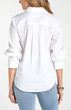 Back view of a woman wearing a White Adjustable Sleeve Button Front Woven Top by liverpool with rolled sleeves