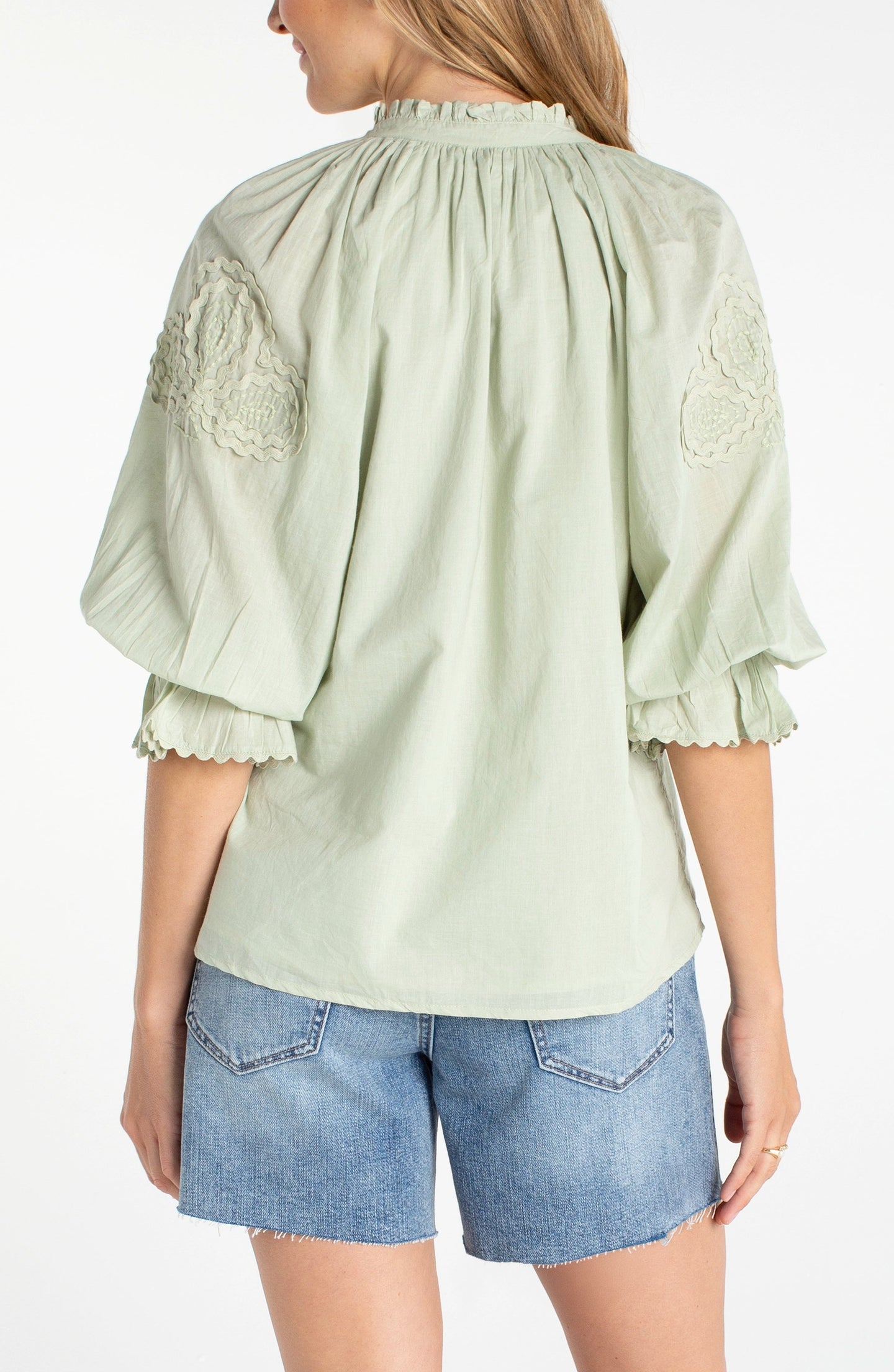 Back view of a woman wearing a light green Matcha 3/4 Sleeve Button-Front Woven Top With Embroidery by liverpool
