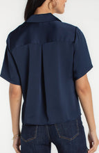 Back view of a woman wearing a Dark Navy Short Sleeve Camp Collar Woven Blouse by liverpool paired with jeans