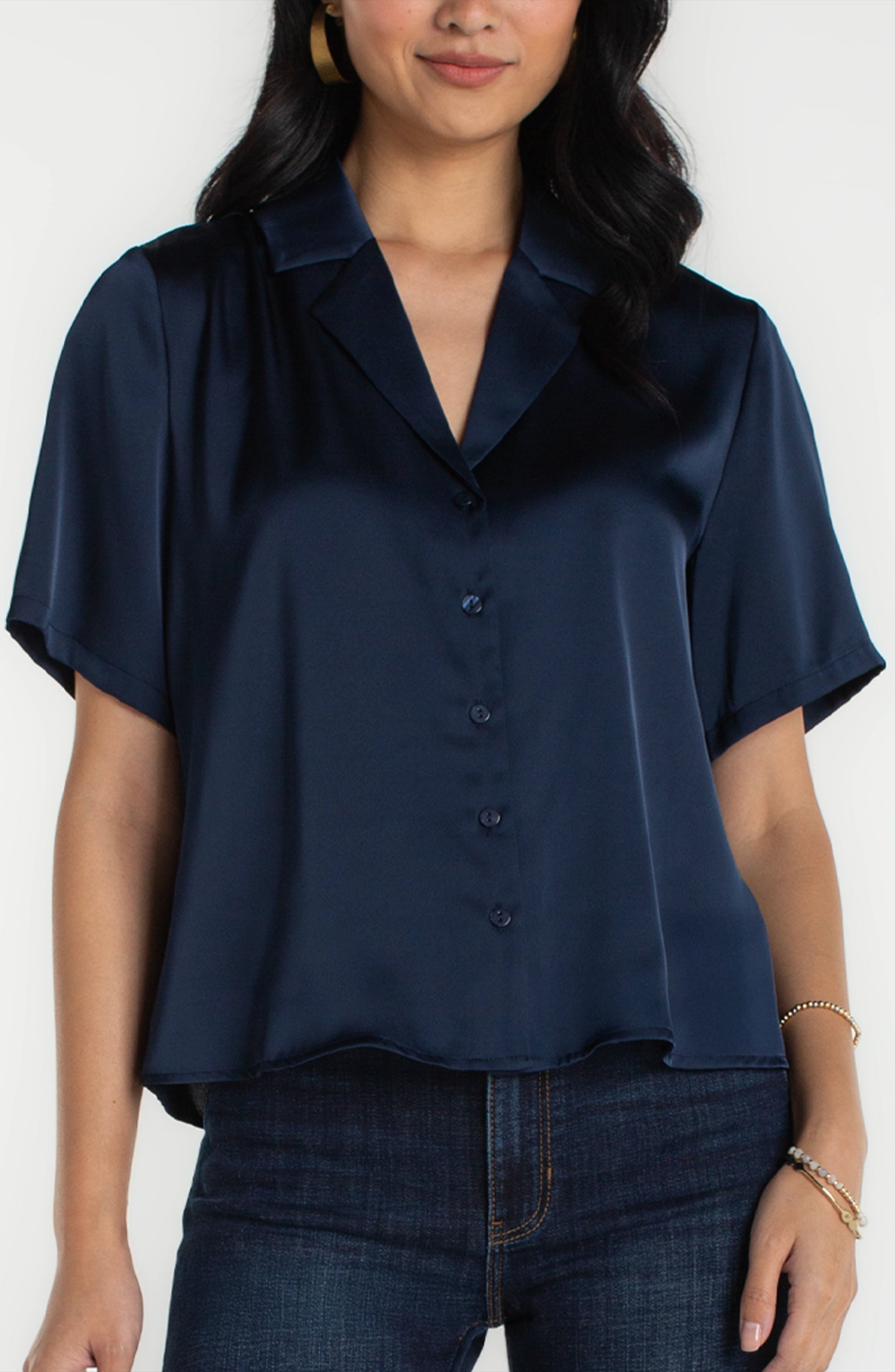 Woman wearing dark navy short sleeve camp collar woven blouse by liverpool paired with dark jeans