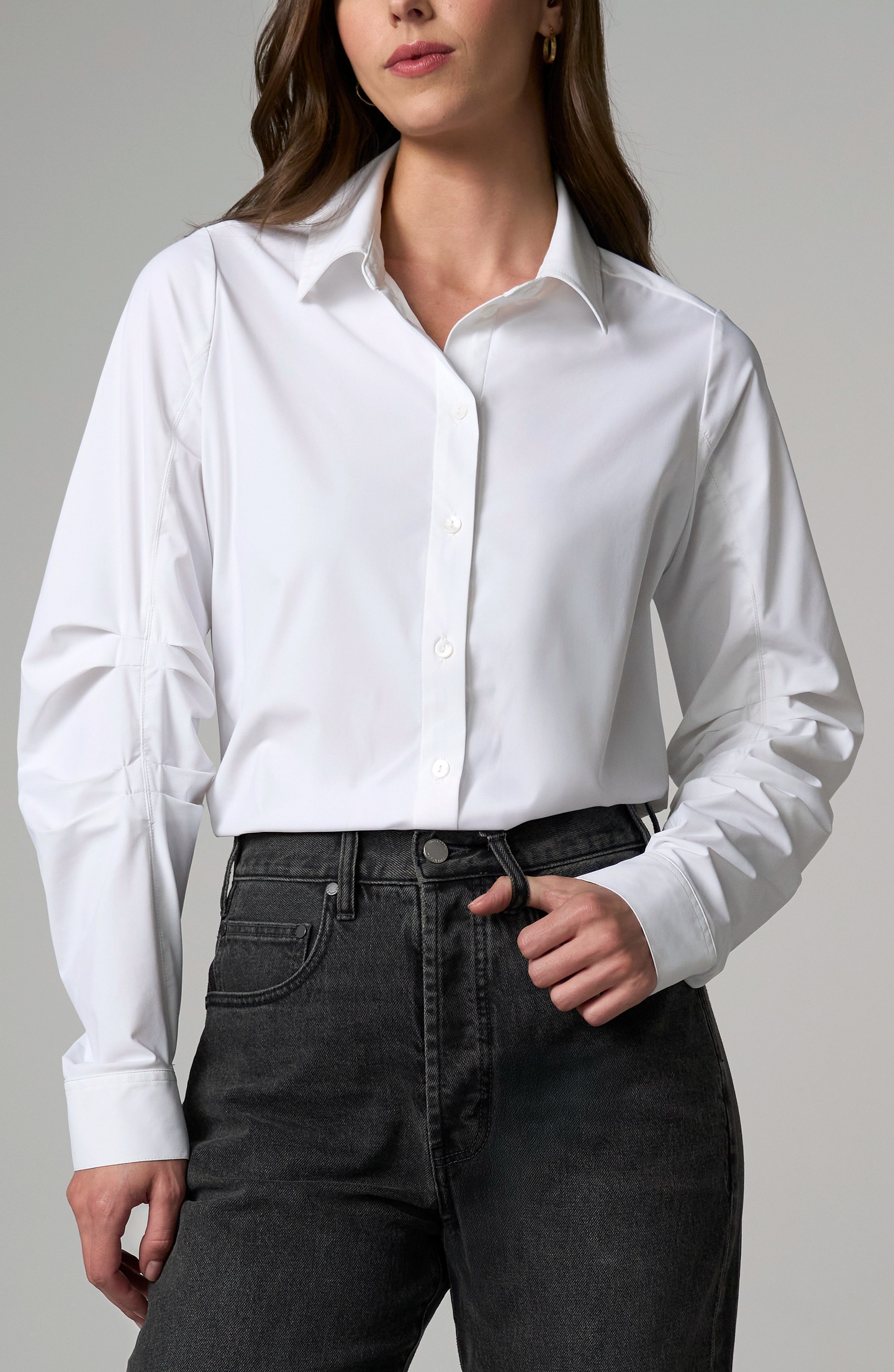 Woman wearing a White Long Pleated Sleeve Button Front Knit Shirt paired with black jeans, styled simply and elegantly.