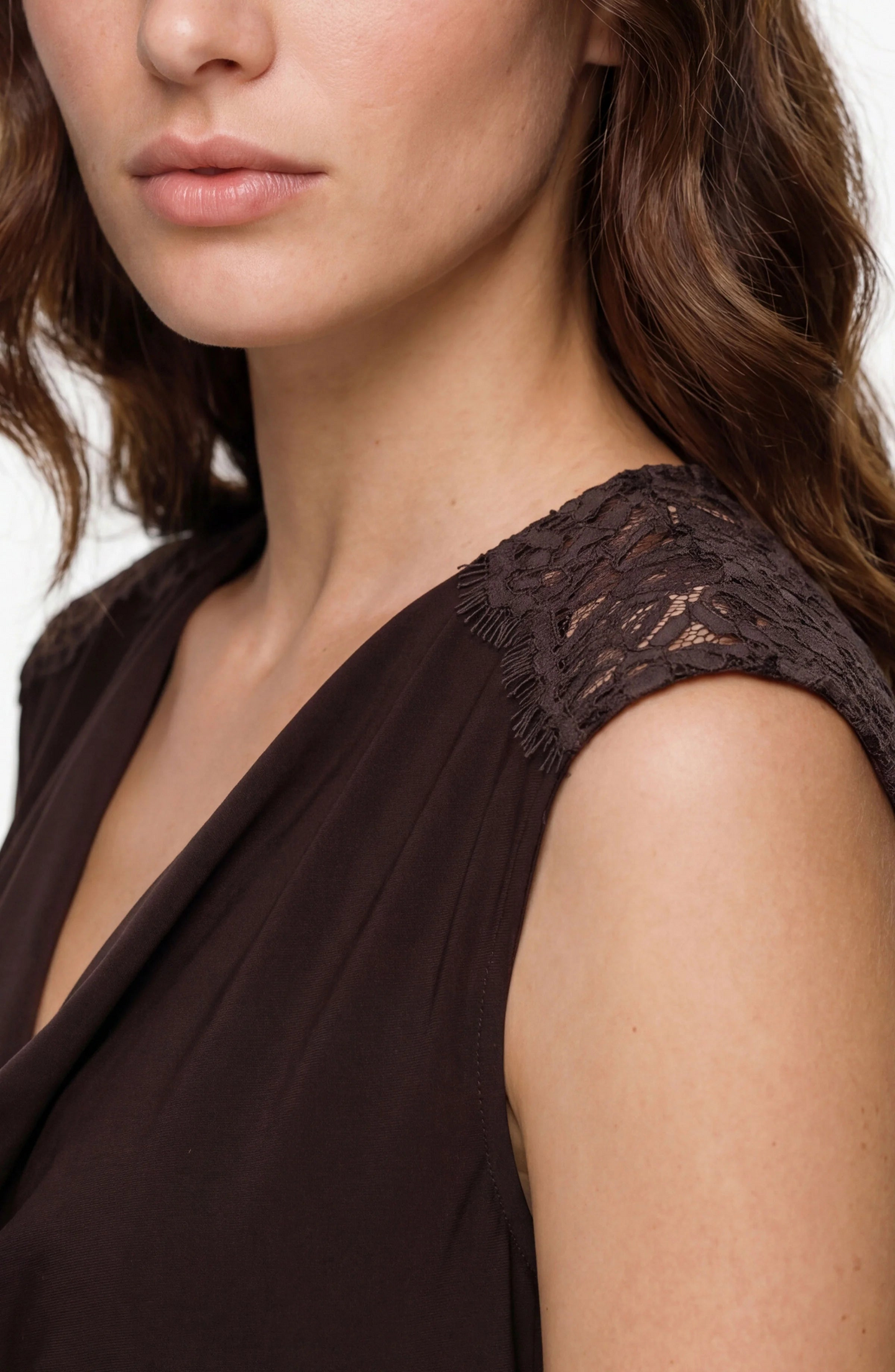 Close-up of a woman wearing Java Lace Trim Tank with delicate lace detail on shoulder by liverpool in dark brown.