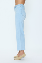 Side view of light wash jeans paired with beige heels, styled with the Eternal Penny Crop by pistola.