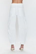 Back view of Pistola White Sabrina pants featuring tailored fit and large back pockets paired with white heels