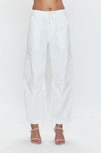White Sabrina pants by pistola with tailored fit and utility pockets in crisp white fabric, styled with strappy heels