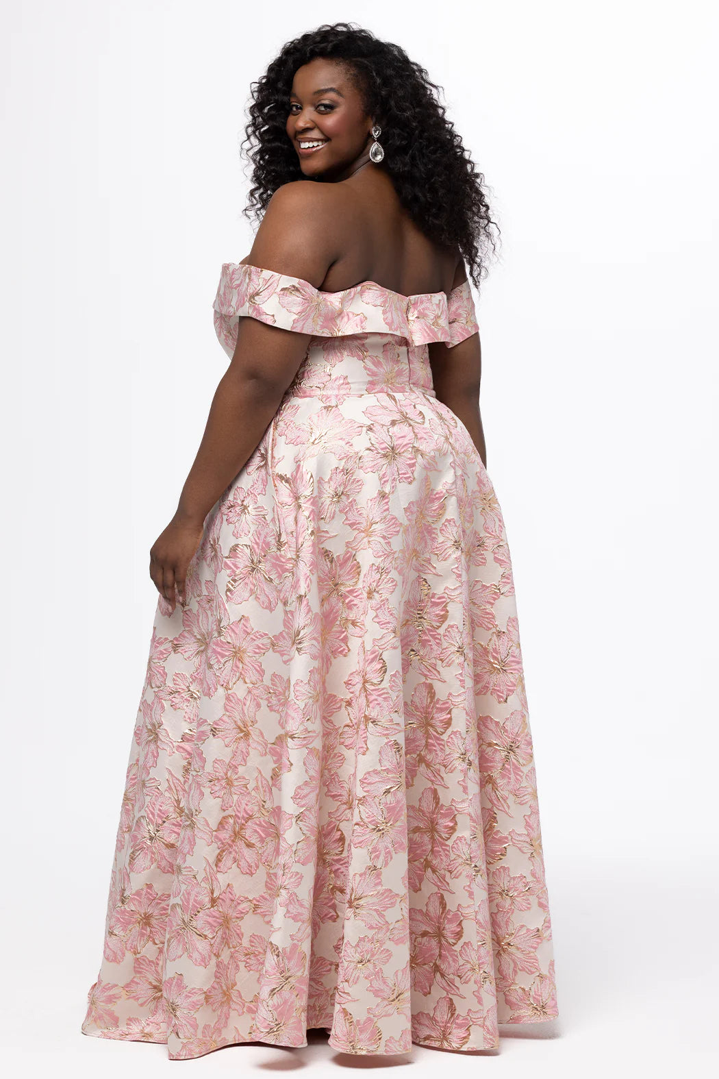 Sydney's Closet Prom Dress Style SC7440 showcasing a light pink floral off-shoulder gown with ruffle detail