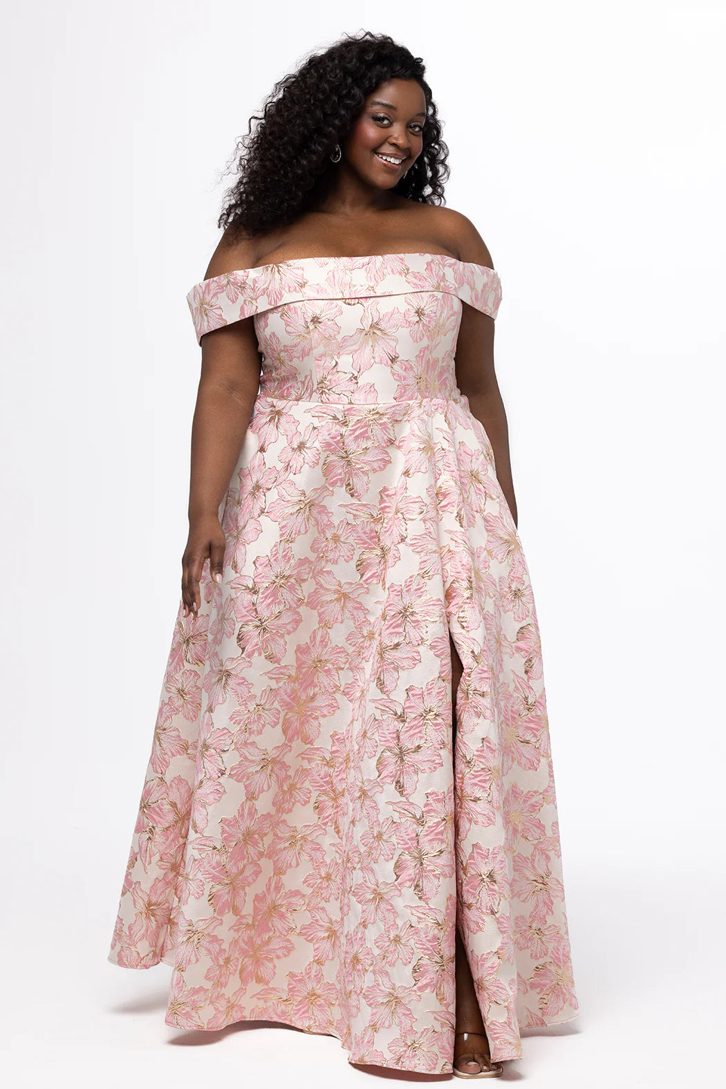 Sydney's Closet Prom Dress Style SC7440 featuring a light pink floral off-shoulder gown with a flowing skirt and slit detail