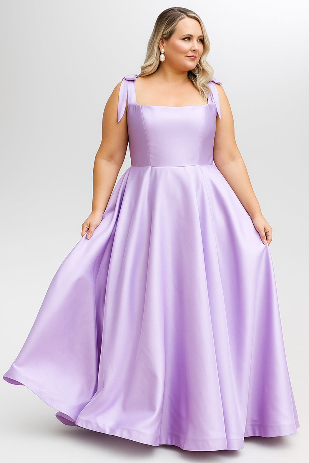 Woman wearing lilac flowing gown with tied shoulder straps in Sydney's Closet Prom Dress Style SC7444 by sydneys closet