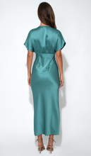 Back view of model wearing Jade Charlotte Flutter Sleeve Midi Dress by Adelyn rae in teal satin finish.
