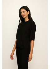 Woman wearing a black shimmering Black Perfect Sequin Sweater Tee by Sanctuary with short sleeves and a relaxed fit