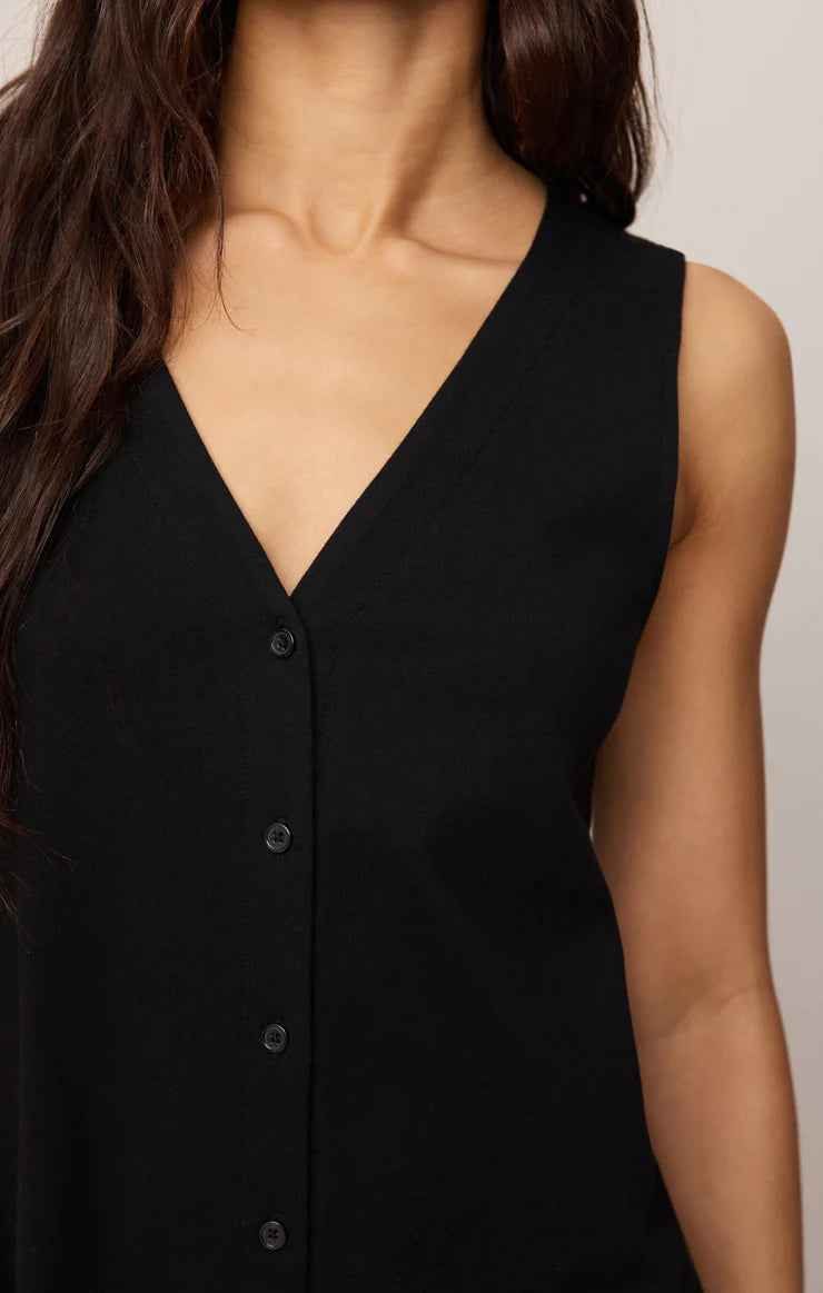 Close-up of a woman wearing sleeveless black Z Supply Solace Mini Dress with button front and V-neckline