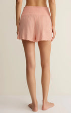 Back view of woman wearing blush pink Z Supply Dawn Smocked Silky Rib Short in textured boutique clothing style