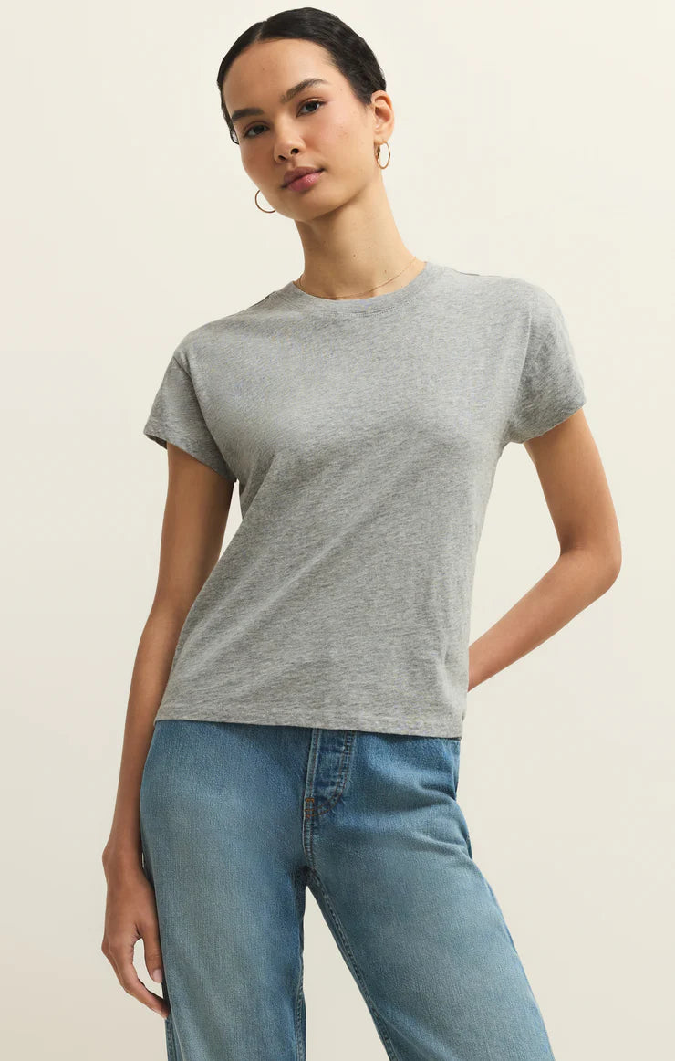 Woman wearing a light gray Z Supply Modern Slub Tee paired with blue jeans against a neutral background