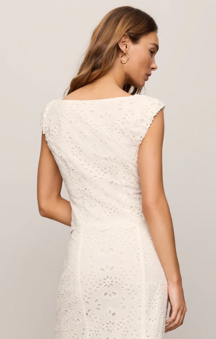Woman wearing a sleeveless White Emrie Eyelet Top by z supply with floral eyelet fabric shown from back side