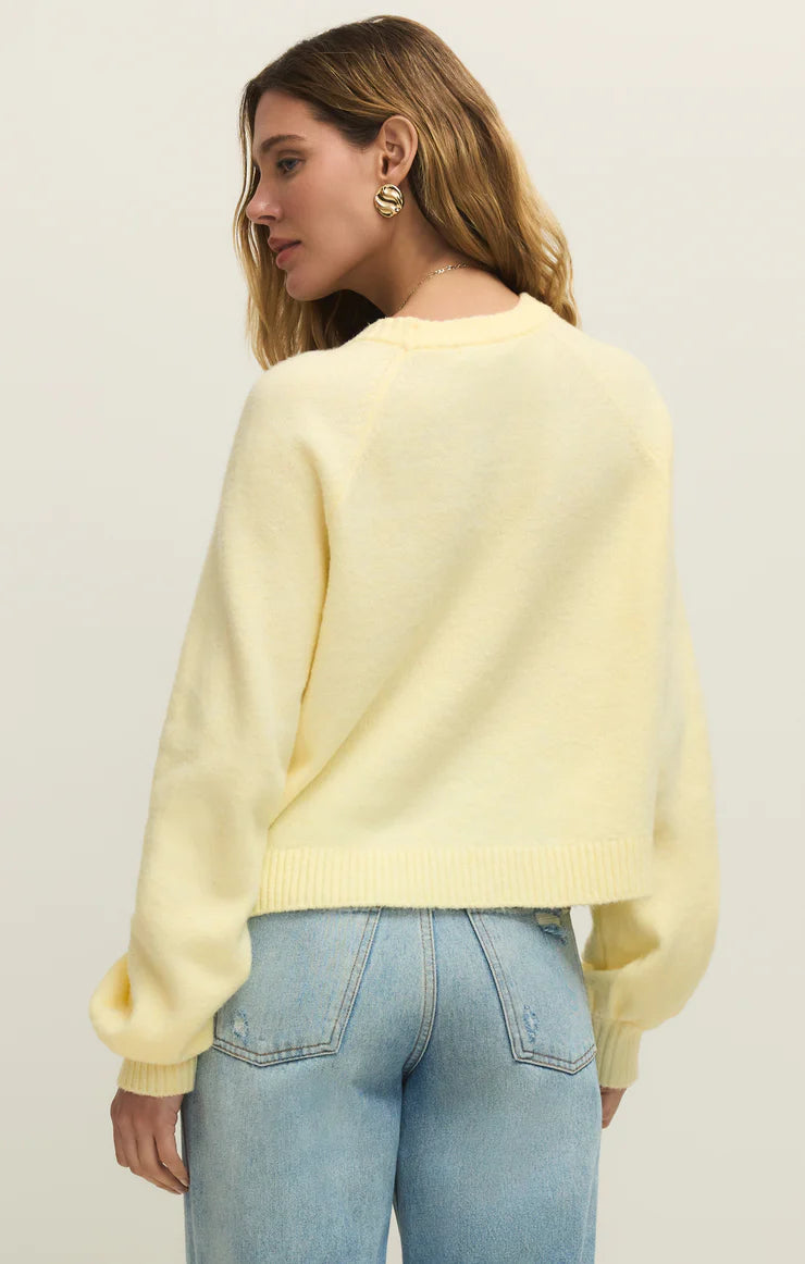 Woman wearing a light yellow Z Supply Pineapple Coming Up Sweater with relaxed fit and textured knit from the back view