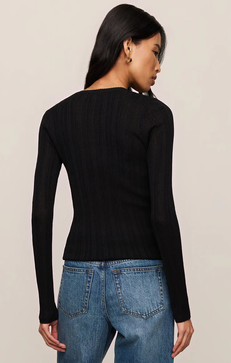 Woman wearing Black Rowena Fine Knit Sweater by z supply, shown from back with long sleeves and fitted design