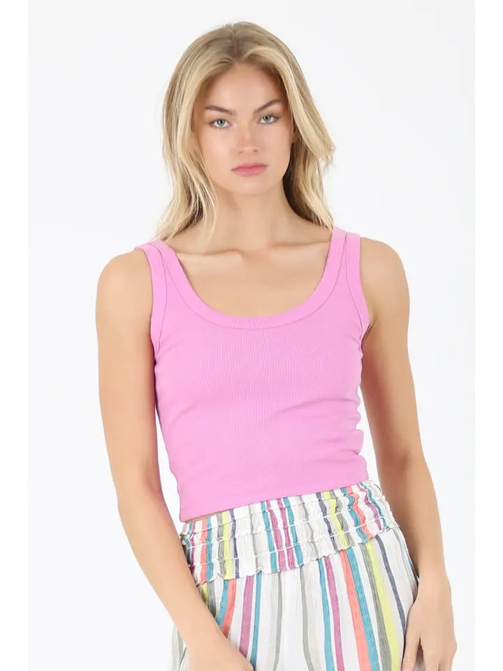 Woman wearing a pink Rib Knit Scoop Neck Tank by angie paired with colorful striped skirt, standing against white background