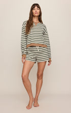 Woman wearing Monstera Low Key Stripe Sweatshirt by z supply in a relaxed striped casual outfit standing barefoot.