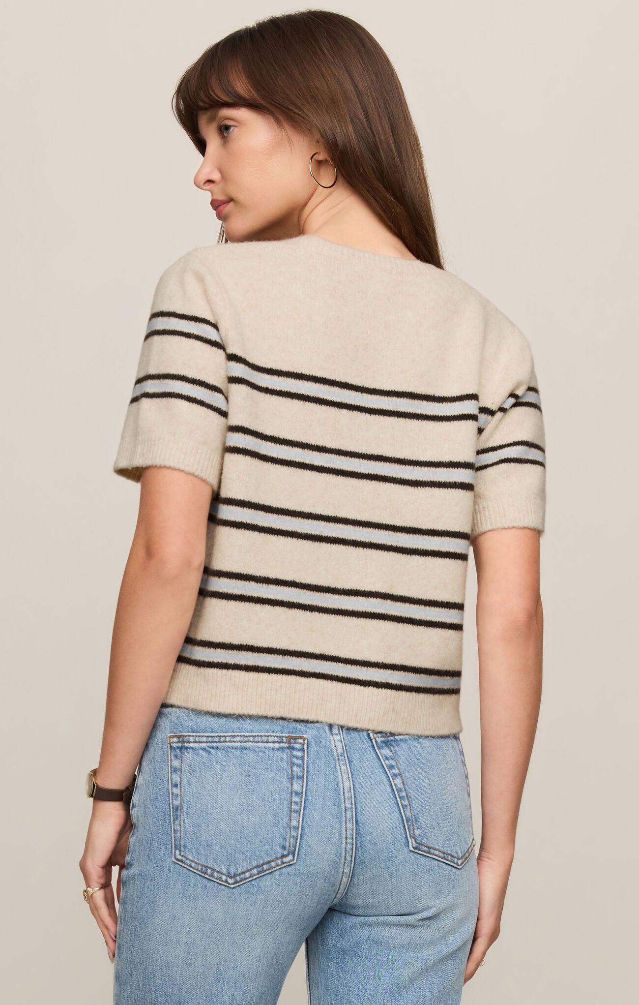 Woman wearing Light Oatmeal Heather Gatewood Stripe Sweater by z supply with short sleeves and fitted hem