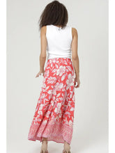 Woman wearing angie Printed A-line Maxi Skirt with white floral pattern shown from back against plain background