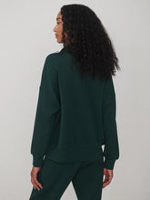 Varley Ponderosa Pine Hawley Half Zip Sweat in dark green worn with matching trousers shown from the back