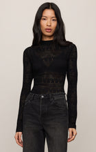 Woman wearing a fitted Black Avery Sweater Top by z supply with lace pattern and high neckline paired with dark jeans