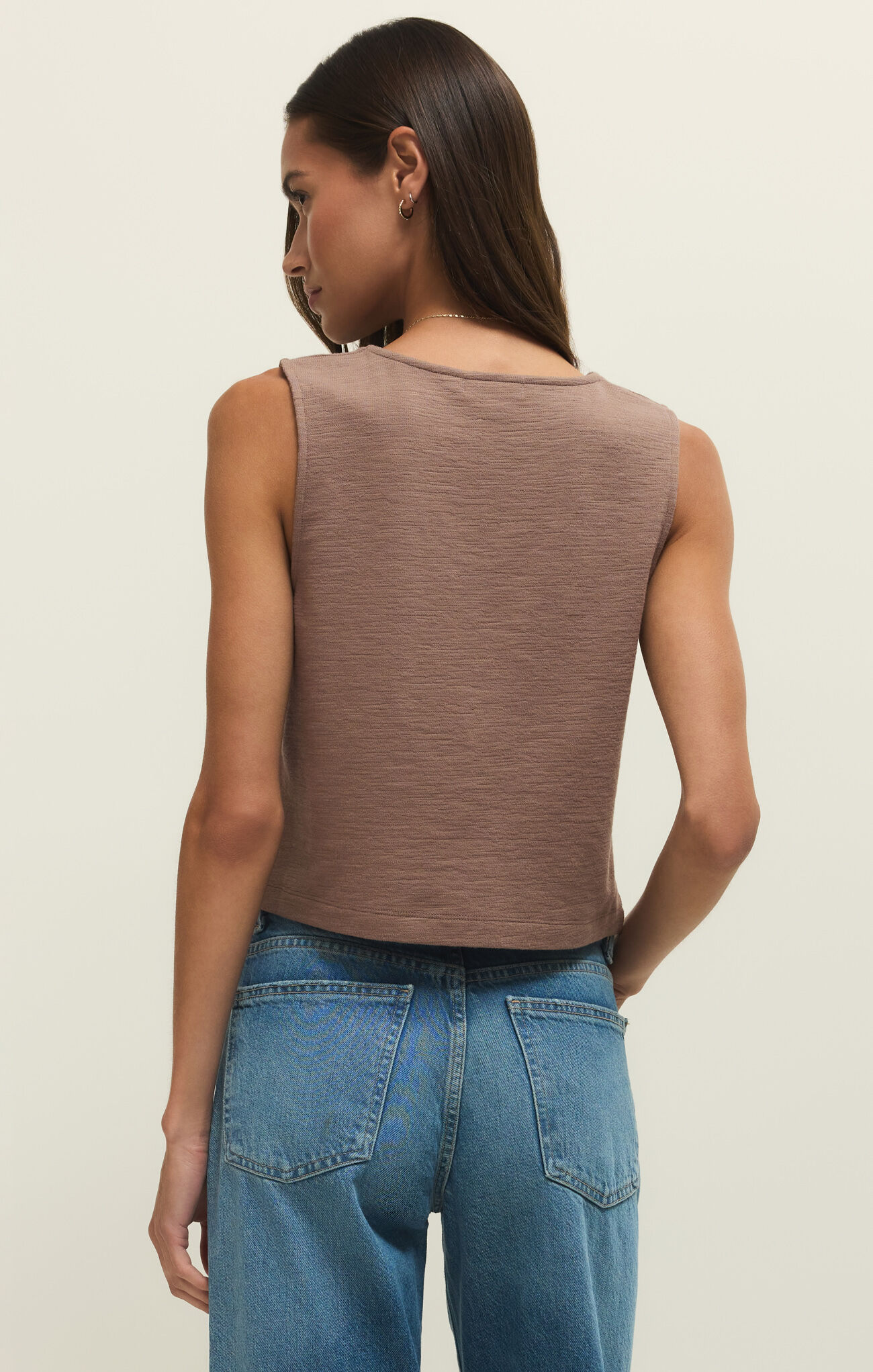 Back view of a woman wearing the Milk Shake Noelle Textured Tank Top by z supply in a soft brown color