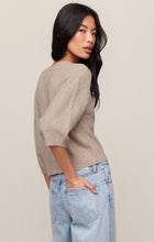 Woman wearing Natural Heather Valor Cardigan by z supply in soft fabric paired with light blue jeans against neutral background