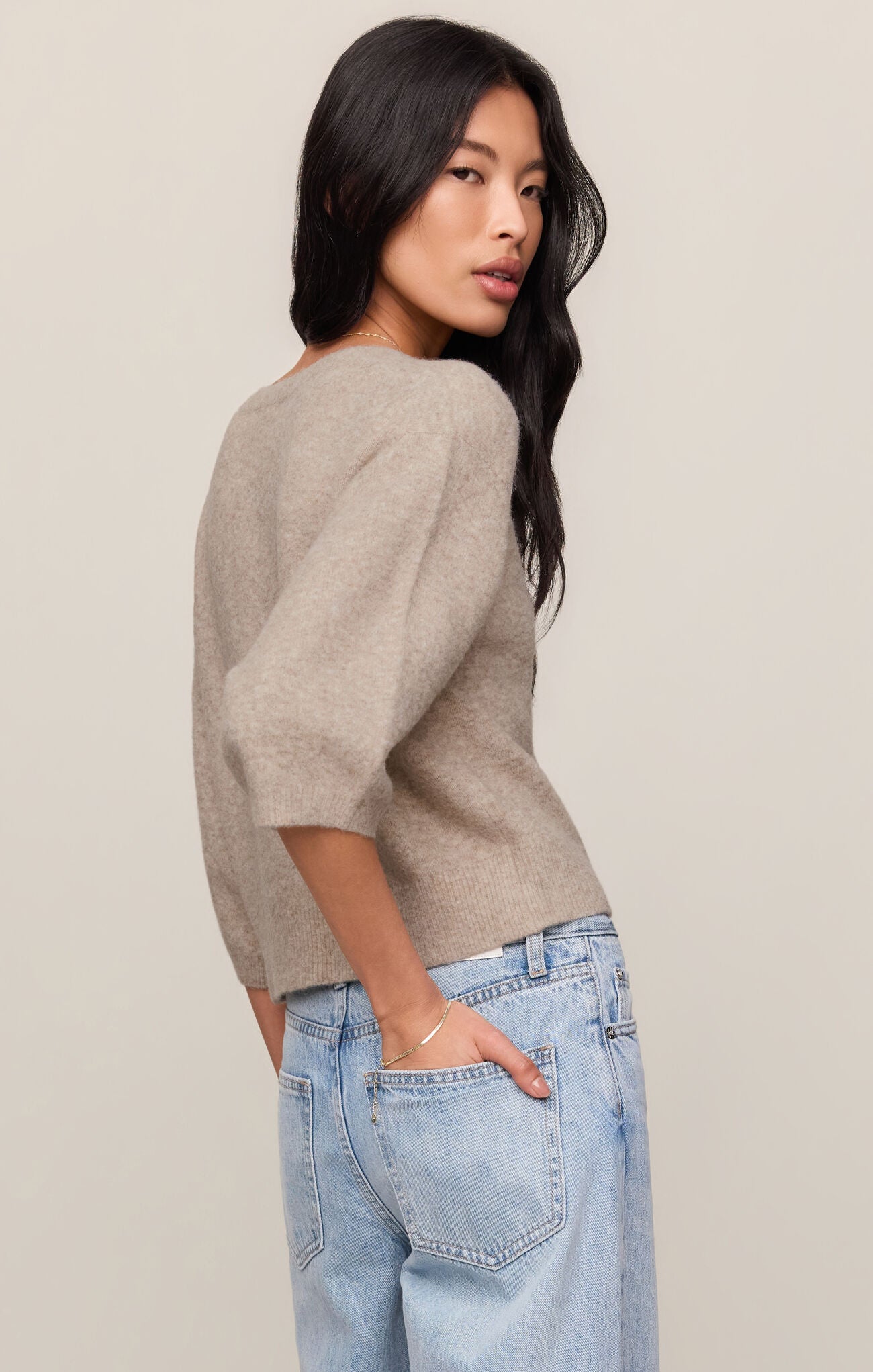Woman wearing Natural Heather Valor Cardigan by z supply in soft fabric paired with light blue jeans against neutral background