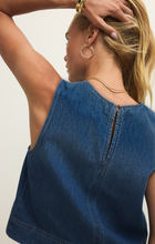 Back view of woman wearing Deep Water Sun Seeker Denim Tank by z supply with sleeveless indigo denim fabric and gold button closure