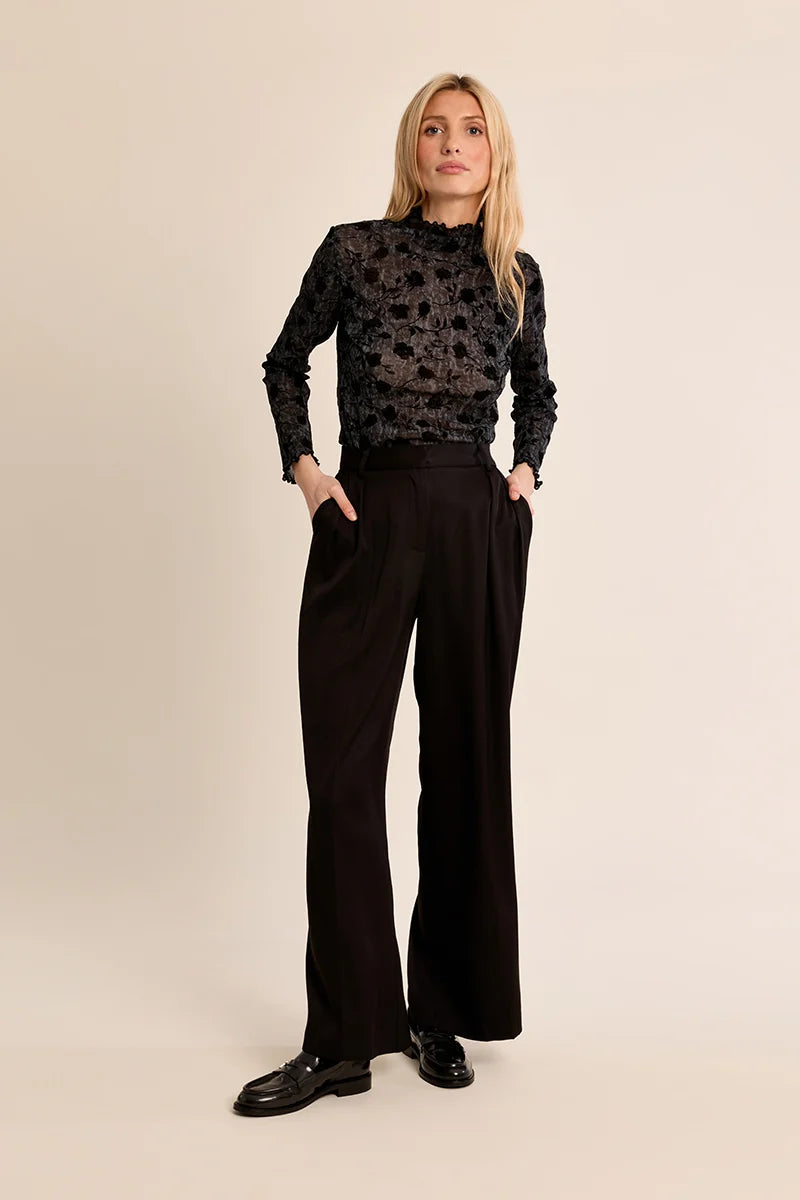 Molly Bracken Top in black floral lace with long sleeves worn by a model