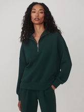 Varley Ponderosa Pine Hawley Half Zip Sweat in dark green worn by a model