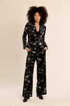 Molly Bracken Black Floral Blazer modeled with matching floral trousers