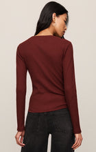 Back view of a woman wearing a maroon Velvet Rouge Albany Waffle Button Up Top by z supply with black jeans.