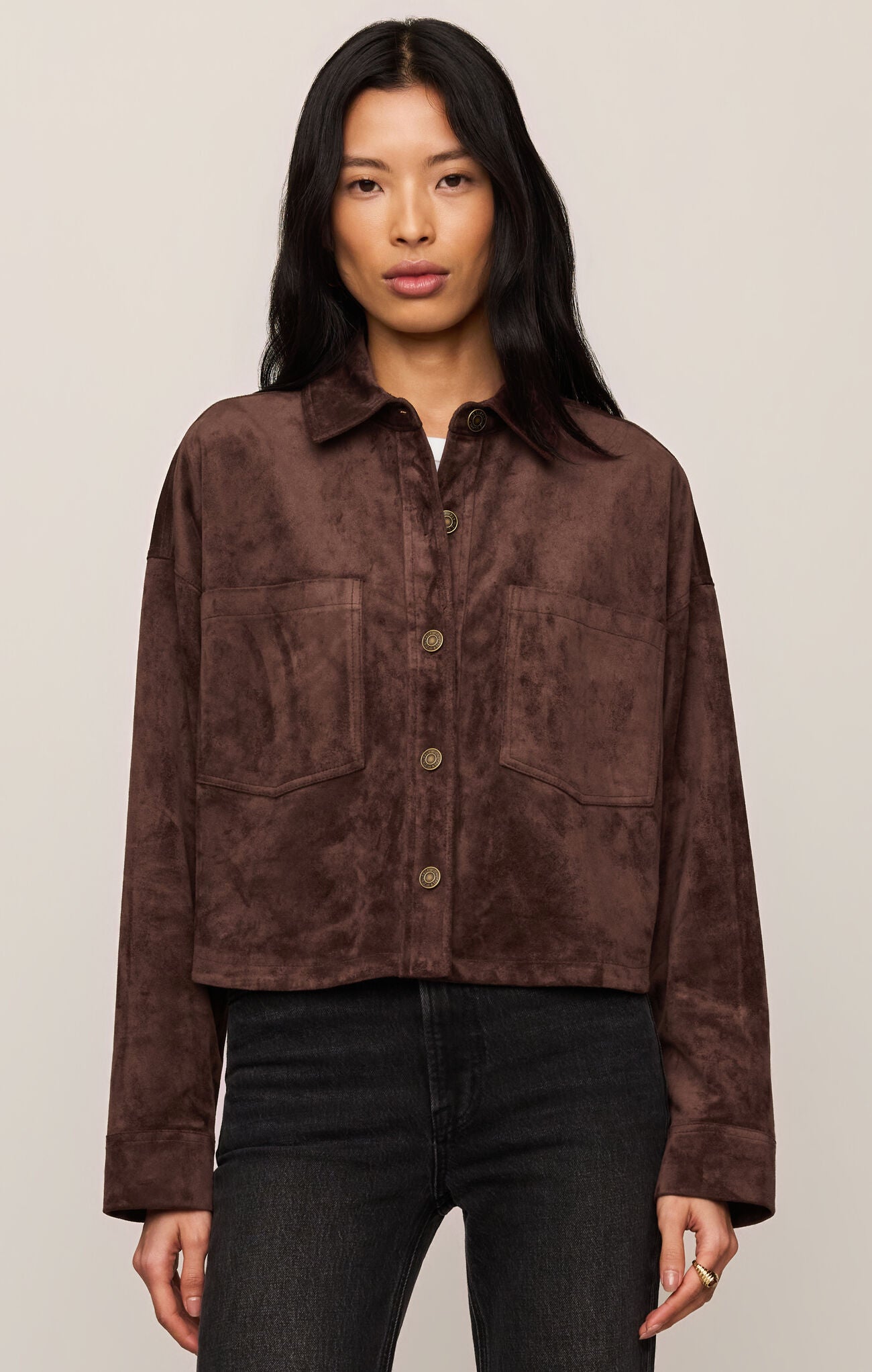 Model wearing a Dark Chocolate All Day Cropped Suede Jacket by z supply with front pockets and button closure