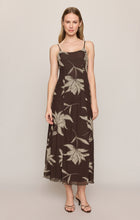 Woman wearing a Dark Chocolate Charisma Floral Midi Dress by z supply with thin straps and floral print design